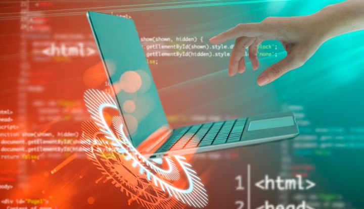 Hands typing code on a laptop keyboard